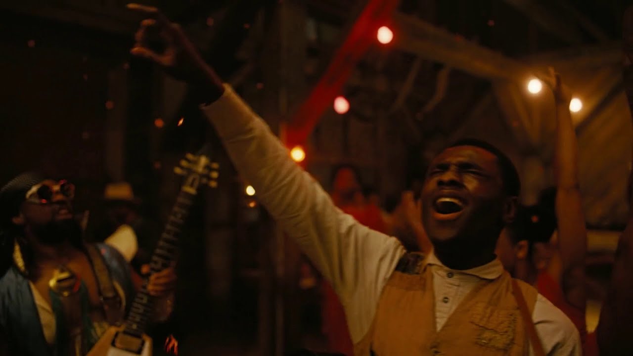 Opening scene in Sinners, Sammie Moore entering his father's church, in tatters and distraught, clutching the neck of his shattered guitar.